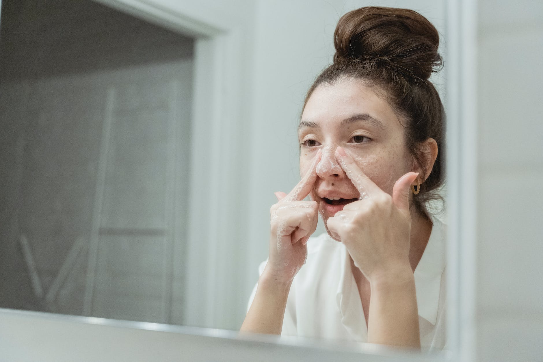 young woman washing her face in the bathroom